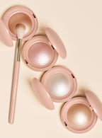 Alternate photo of all highlighter compacts with an application brush