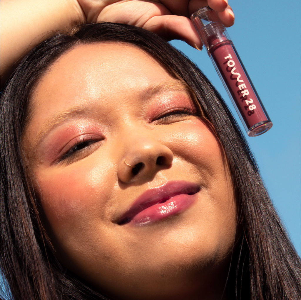 A model wearing the Tower 28 Beauty ShineOn Lip Jelly in the shade Sesame on her lips. [Sesame]