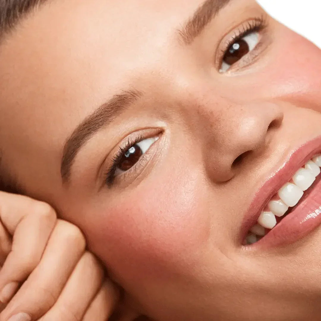 Close-up of model wearing soft pink blush with a radiant, dewy finish and natural makeup look.