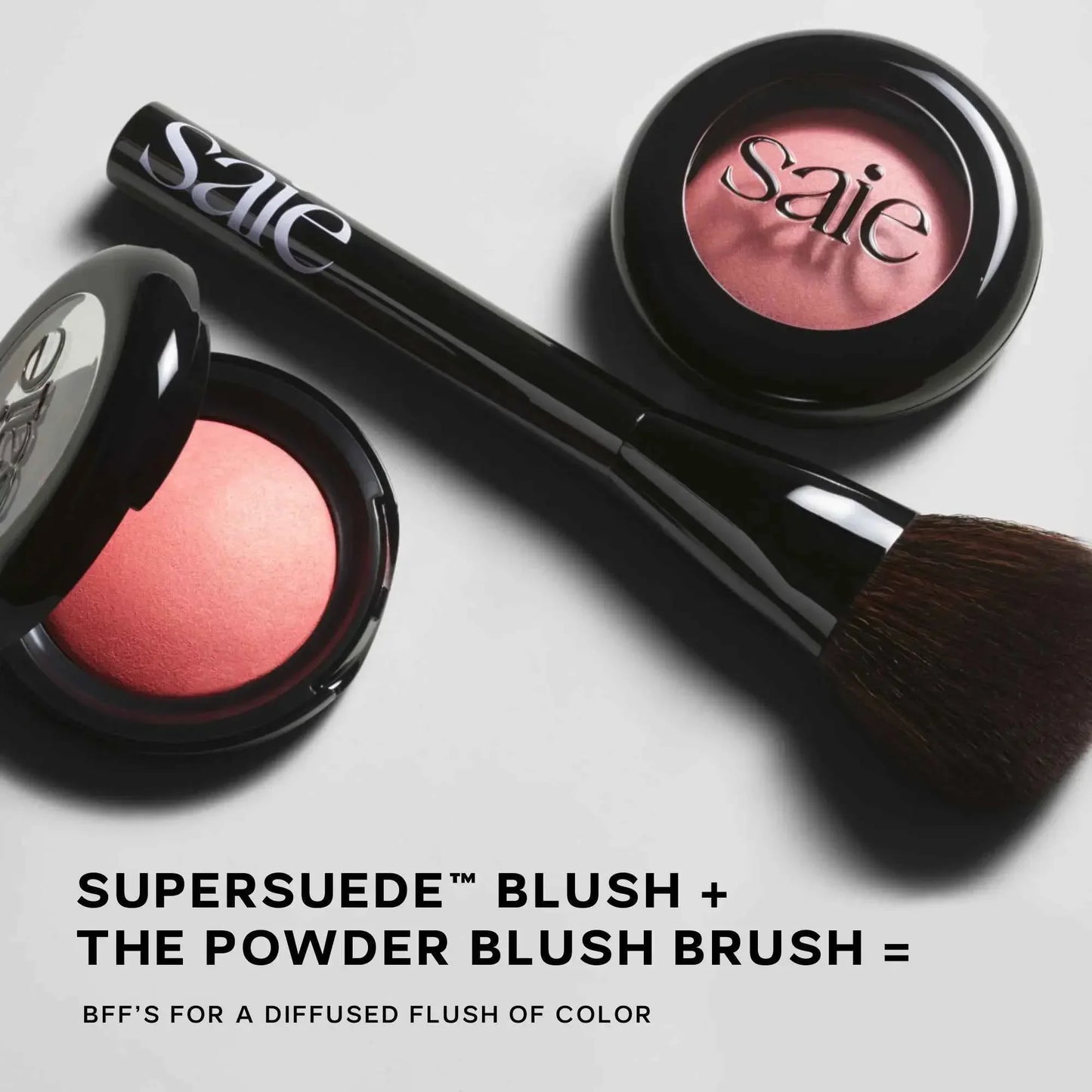 Luxurious pink powder blush with soft powder brush, featuring a rich, matte suede texture.