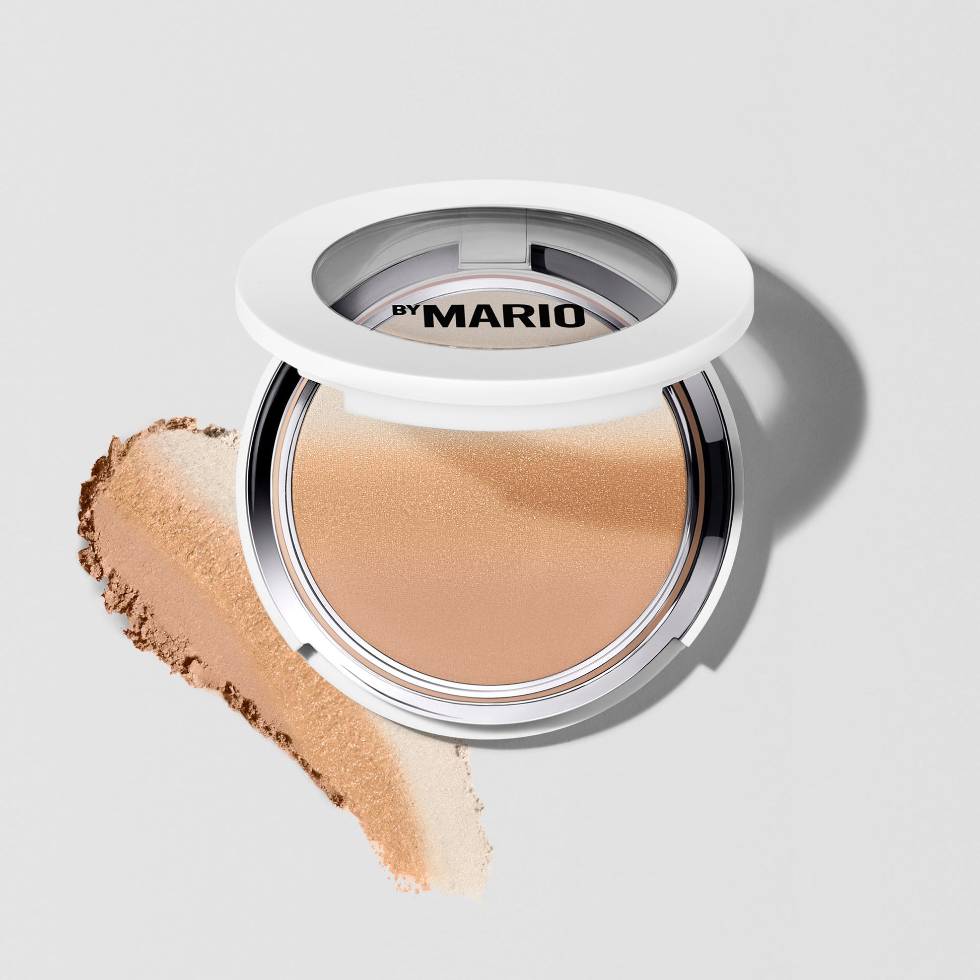 Pressed powder compact in light warm shade with silky, smooth texture for fair to light skin tones