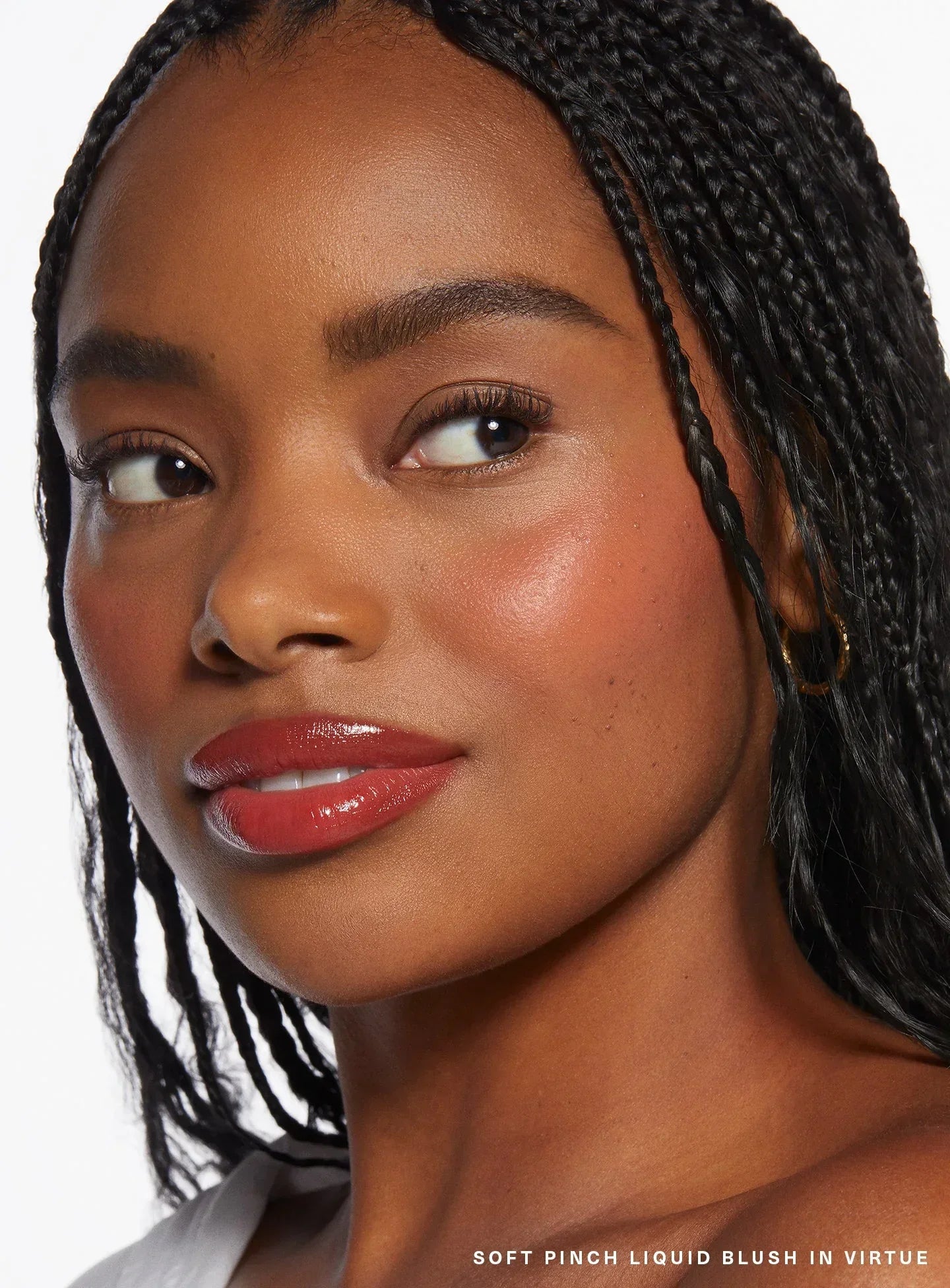 Virtue| Rare Beauty's Soft Pinch Liquid Blush in the dewy beige peach shade "Virtue" applied on a model.