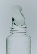 closeup of rhode peptide lip treatment (unscented) with product squeezing out